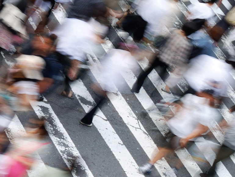 Stream of people on a pedestrian crossing